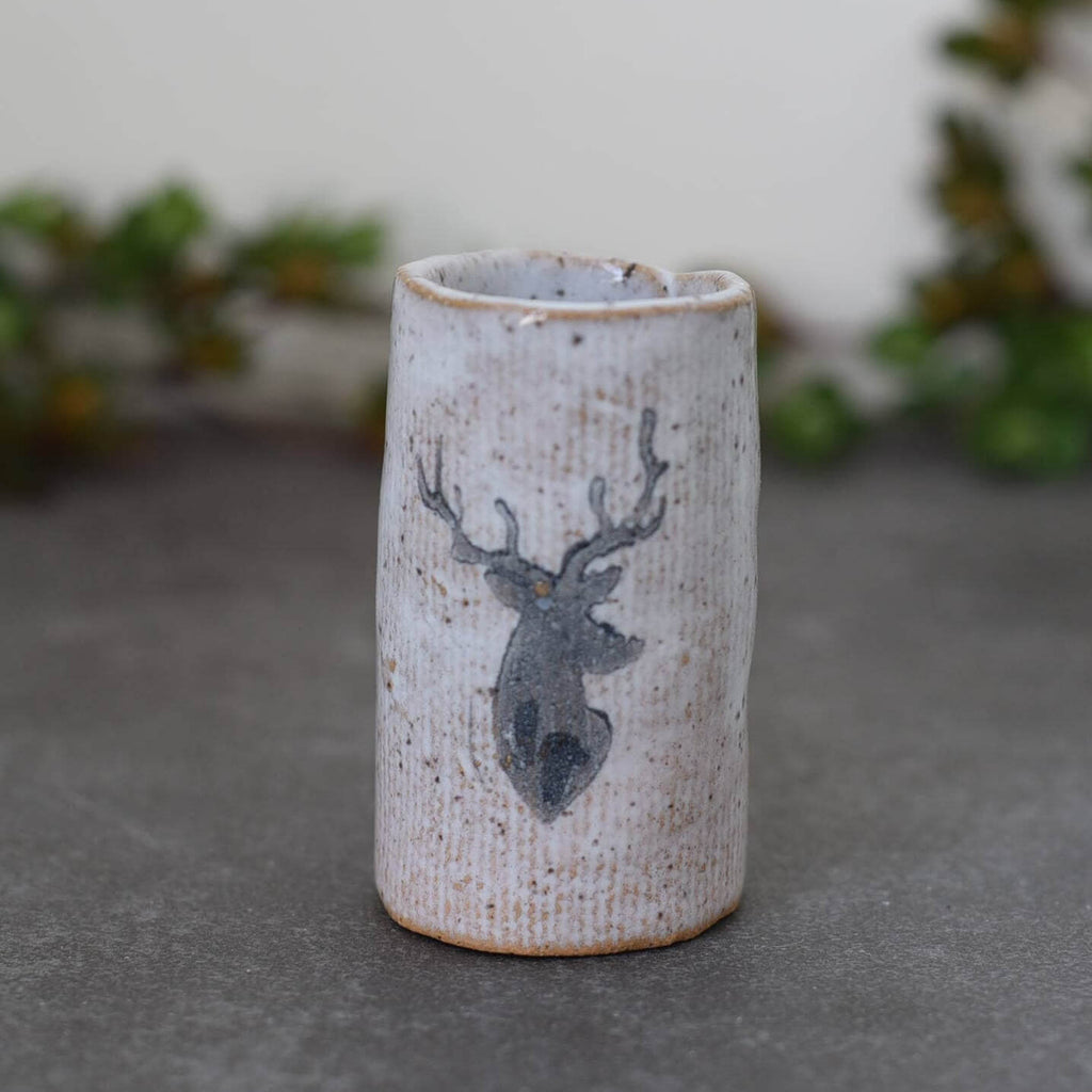 Ceramic shot glass with buck design